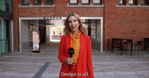 Presenter in a red blazer outside a Perth museum