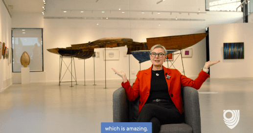 Presenter speaking in a gallery space